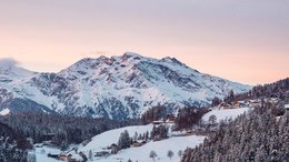 Ihre Hotels in Meran in Südtirol: Hotels im Meraner Land Verschneite Alpenberge mit kleinen Dörfern bei Sonnenuntergang
