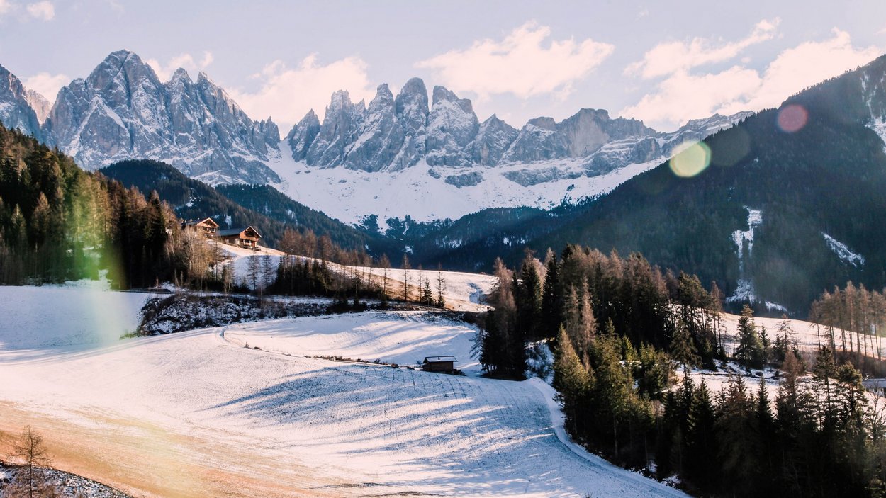 Il bello delle piste in Val di Casies Paesaggio montano innevato con alberi e case nella valle alla luce del sole