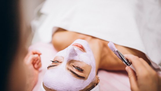 Medical Wellness Hotels in Südtirol Frau bekommt Gesichtsmaske im Spa aufgetragen