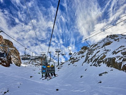 L’area sciistica di Solda all’Ortles Seggiovia con sciatori sotto cielo blu su montagna innevata
