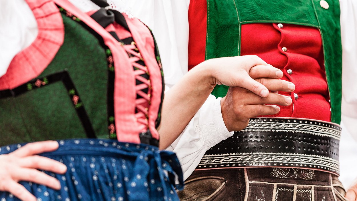 Le tradizioni del Trentino-Alto Adige Coppia in abiti tradizionali bavaresi che si tiene per mano