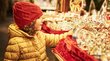 Mercatino di Natale di Merano Bambina con cappello rosso guarda sfere di Natale in bancarella