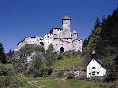 Schloss Welsperg im Oberpustertal in Südtirol Mittelalterliche Burg auf bewaldetem Hügel unter blauem Himmel