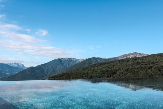 Unterkunft mit Infinity Pool in Südtirol Infinity-Pool mit Bergblick unter klarem blauem Himmel