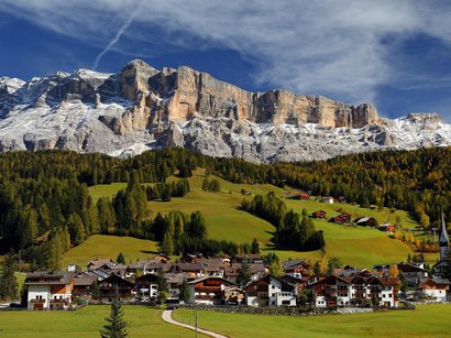 Hotel a La Villa in Val Badia Villaggio ai piedi di montagne innevate con prati verdi e boschi