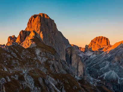 Hotel a San Cassiano in Val Badia Vette di montagna nelle Alpi illuminate dal tramonto arancione