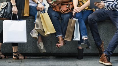 Centrum Gruppo di persone sedute con borse della spesa che usano cellulare e tablet