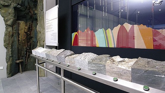 Centro visite in Valle Aurina Esposizione di diversi campioni di rocce con mappa colorata delle montagne sullo sfondo